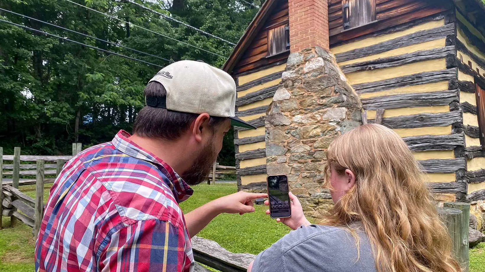 Standing outside fo   With just a smart phone, visitors at Montgomery County's Oakley Cabin can learn about African American life after emancipation through an augmentative reality experience, including virtual park guides, property fly-overs and 3D models of the interior as iUMD's Postdoctoral Associate Stefan Woehlke standing outside of Montgomery County's Oakley Cabin 