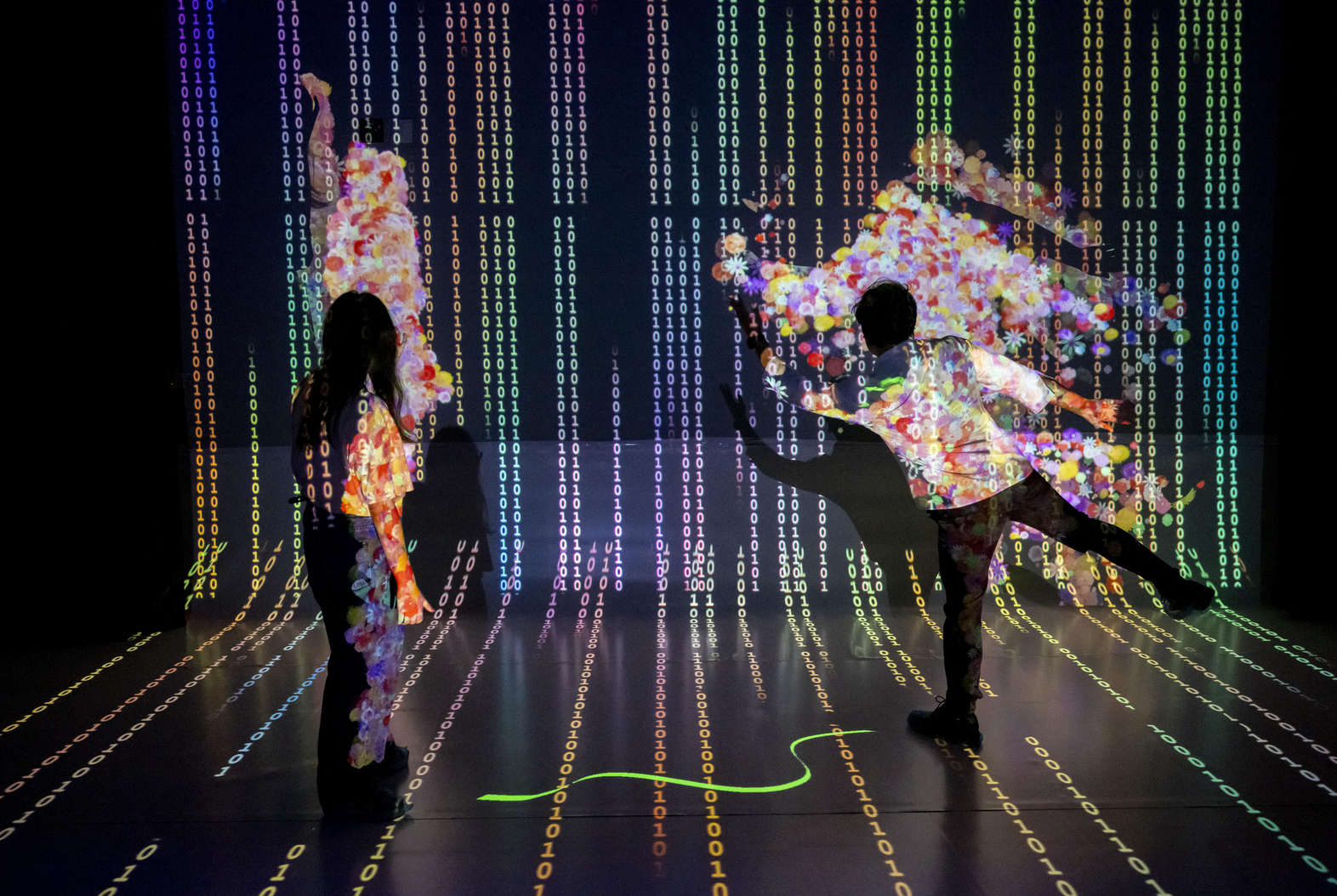Two Immersive Media Design student dancing to an immersive media art project.