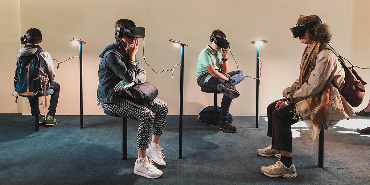 Photo of 4 people wearing VR headsets by Lucrezia Carnelos on Unsplash